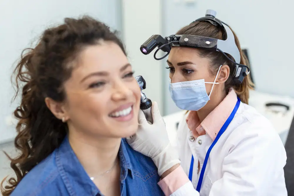 hearing exam otolaryngologist doctor checking woman s ear using otoscope auriscope medical clinic